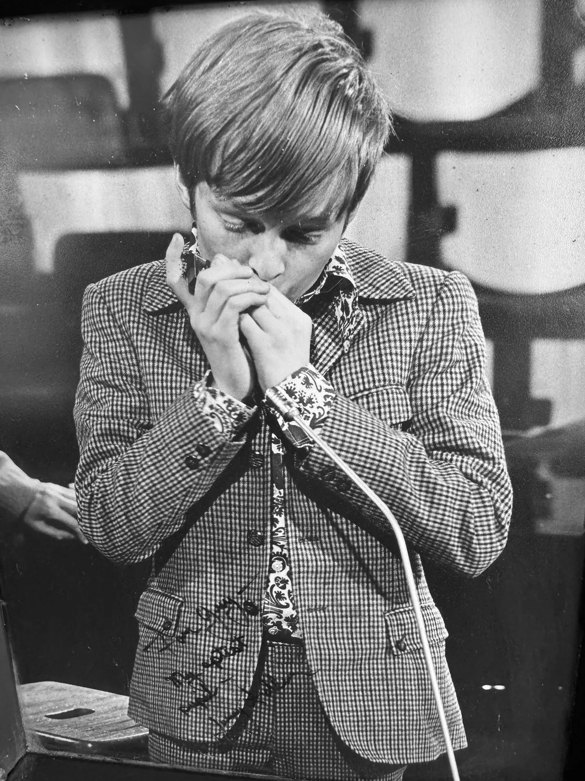 A young Guy Michelmore playing harmonica on ITV